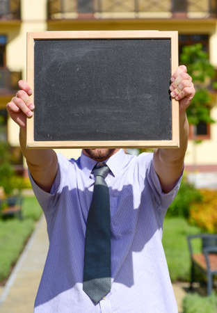 Business and real estate concept. Estate agent holds blackboardの写真素材
