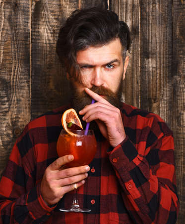 Handsome bearded brutal man on wooden backgroundの写真素材