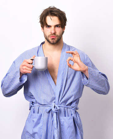 Man with beard in blue dressing gown on grey background.の写真素材