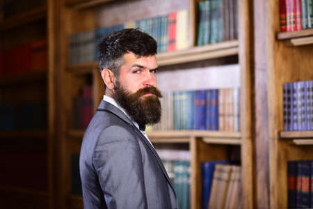 Teacher stands in library and looks confident.の写真素材