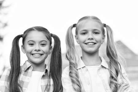 Perfection in beauty. Happy kids with long hair tails. Beauty look of small girls. Beauty shop. Hair salon. Fashion and beauty. Haircare and skincare products. We are here to beautify the worldの写真素材