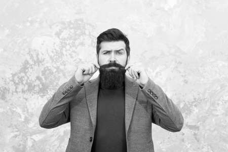 Barbershop service. Elegance stays in fashion. Fashion model touch his moustache. Man wearing autumn jacket. Jacket makes man look more elegant. Business success. get warm and comfortable this seasonの写真素材