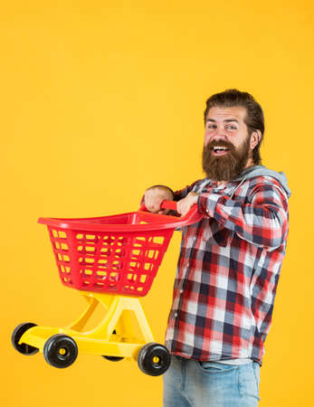 bearded man go shopping with empty shopping cart.の写真素材