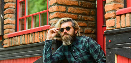 Brutal male with blond hair irish architecture background. Man casual fashion. Hipster in...