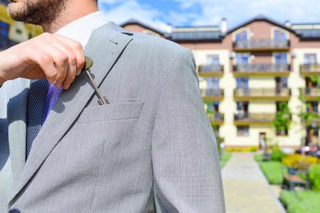 Businessman putting key in pocket Concept of business plan