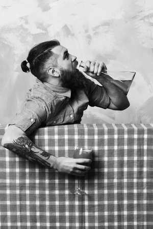 Brutal caucasian hipster with alcohol cocktail and flaskの写真素材