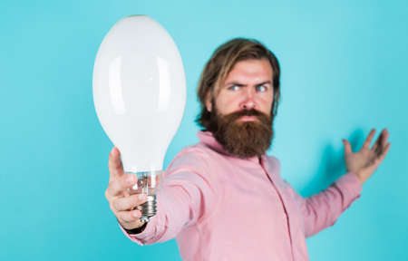 bearded thinking man hold bulb. Energy saving. innovative idea and innovation. modern thinking. Solution to problem. new idea generator. Business idea and creativity symbol. selective focusの写真素材