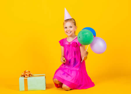 lets have fun. Happy child plays with balloons. happy kid with present box. happy childrens day. childhood happiness. Concept of freedom and imagination. funny girl have fun on holidayの写真素材