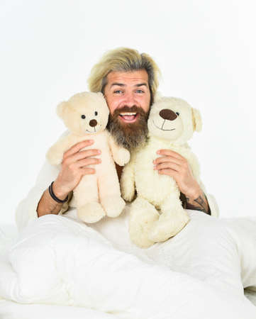 togetherness. Sick man with flu lying in the bed. sleeping at home in bed with his toy. man sleeping...