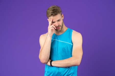 Man muscular handsome unshaven thoughtful guy on violet background. Masculinity concept. Does having muscular body make you more confidentの写真素材