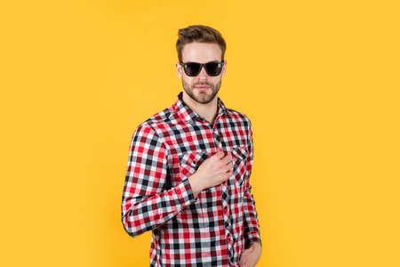 Confident in his choice. handsome confident young man standing in shirt and glasses. sexy guy looking. portrait of fashionable handsome man in shirt. business classic mens shirts with checkered printの写真素材