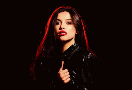 Vampire aesthetics. Red lips smoky eyes. Passionate lady. Desire concept. Wild energy inside. Impeccable appearance. Mysterious passionate fashion model. Passionate attractive woman makeup faceの写真素材