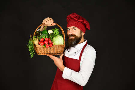 Chef with cabbage, radish and lettuce. Man holds veggiesの写真素材