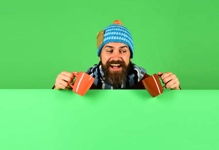 Autumn and hot drink season concept. Man in warm hatの写真素材