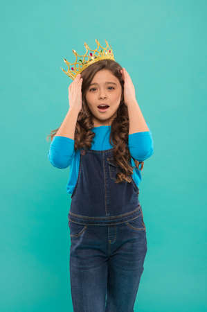 oh my god. little princess. selfish kid long curly hair. luxury and success. find your motivation. small girl in queen crown. feel herself like big boss. being an egoist. reward for real championの写真素材
