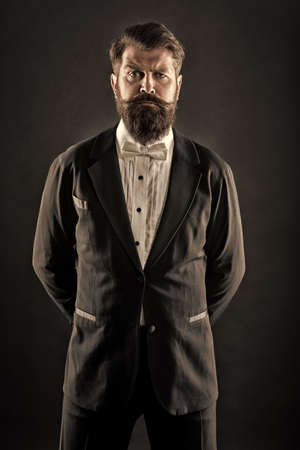 Well dressed and scrupulously neat. Hipster formal suit tuxedo. Official event dress code. Male fashion. Classic style. Classic never out of trend. Menswear classic outfit. Bearded man with bow tieの写真素材