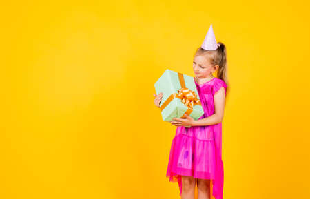 being excited and surprised to get birthday present. Smiling funny child. Happy child hold shopping gift. cyber monday sale. Kids shopping. cheerful little shopaholic. copy spaceの写真素材