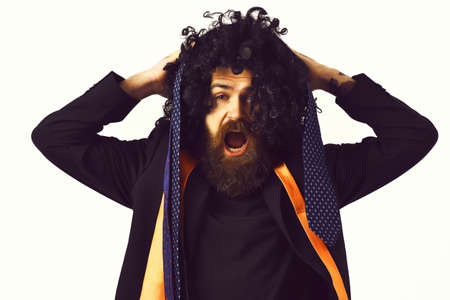 caucasian hipster in suit and black curly wigの写真素材