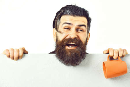 Bearded brutal caucasian hipster with paper sheet and cup