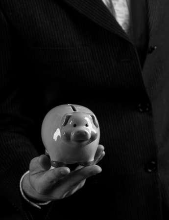 piggy bank in male handsの写真素材