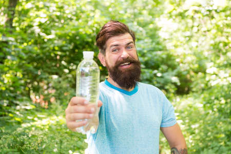 Drink Plenty Of Water. drinking water in forest outdoor with sunset nature on background. Bearded...
