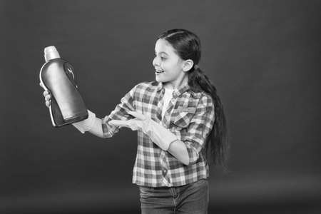Cleaning supplies. Disinfecting gels suitable for all family. Girl in rubber gloves for cleaning hold plastic bottle chemical liquid. Help clean up. Use product for cleaning. Housekeeping conceptの写真素材