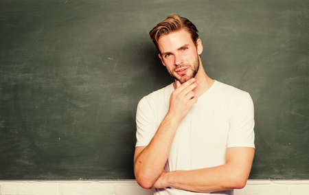 Get your best Solutions. student man in classroom. University exchange. education abroad. Student exchange. college life. young tutor. teacher day. prepare for exam. back to school. man at blackboardの写真素材