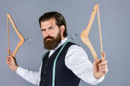 fashion model. Handsome man in smart casual wear is holding hanger.の写真素材