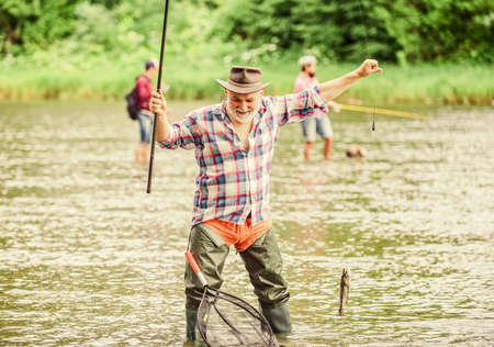 life full of new Hobbies. summer weekend. fisherman with fishing rod.の写真素材