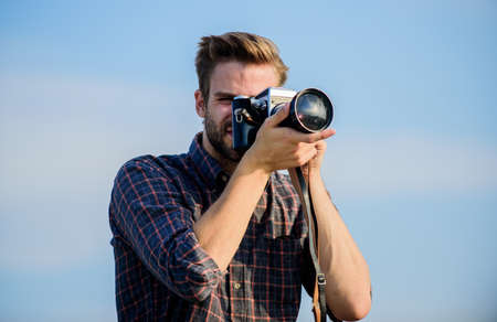 A new moment captured. photographer in glasses. capture adventure. journalist. travel with camera. male fashion style. looking trendy. macho man with camera.   man touristic reporterの写真素材