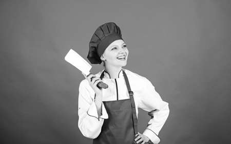 professional chef in kitchen. Cuisine. happy woman cooking healthy food by recipe. butcher cut meat. Housewife with cooking knife. woman in cook hat and apron. Bite moreの写真素材