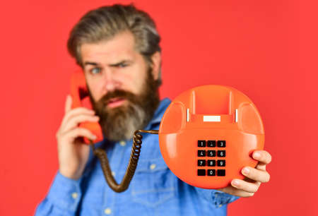 Man talking to vintage phone. businessman talking on vintage phone. buy new gadget. phone business...