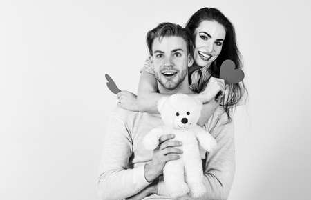 Valentines day concept. Valentines day and love. Romantic ideas celebrate valentines day. Man and woman couple in love hold red heart valentines cards white background. Man and pretty girl in loveの写真素材