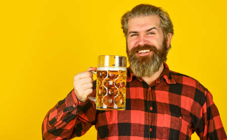 handsome man sipping delicious beer. enjoying glass of beer at pub. anticipating fresh cold lager...