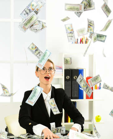 woman director has business success. successful businesslady with case. Internet earnings of fake money. bribe and money laundering. dollar currency cash. Wealth and rich. dirty moneyの写真素材