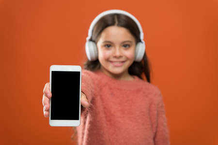 Best music apps for free. Listen for free. Get music account subscription. Access to millions songs. Enjoy music concept. Enjoy perfect sound. Girl child listen music modern headphones and smartphoneの写真素材