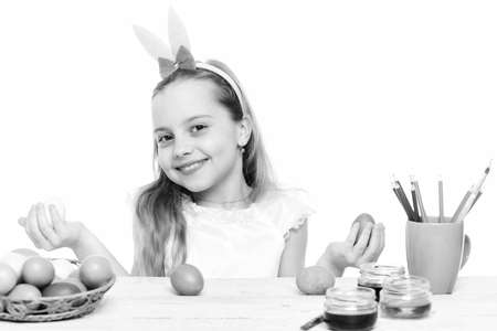 small happy baby girl with easter eggs isolated on whiteの写真素材