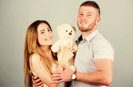 Future parents. valentines day present. sexy girl and man hold teddy bear. romantic relationship. love date. man and woman embrace. couple in love. family relations and happiness. family valuesの写真素材