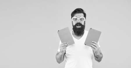 how to make exercise. bright ideas for your studying. happy man in glasses with notebook. graduate from university. back to school. mature student presenting some books. office accessory. copy spaceの写真素材