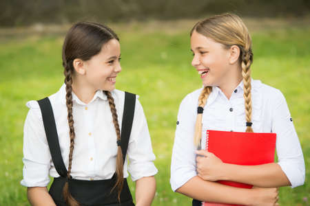 nice spring day. Education and distance learning for kids. Homeschooling during quarantine. Child care and happy childhood. teen schoolgirls doing homework. Children using copybooks to studyの写真素材