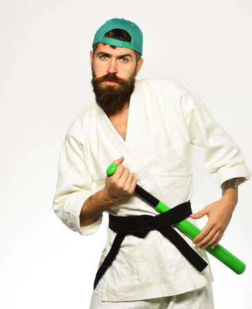 Man with beard in kimono and green cap on whiteの写真素材