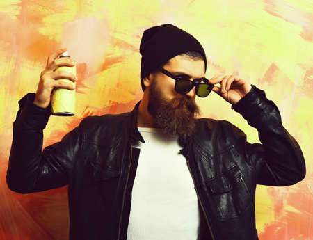 Bearded brutal caucasian hipster holding spray paintの写真素材