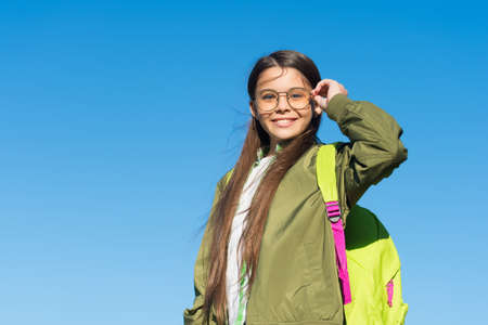 New point of view. Happy girl carry travel bag on sunny blue sky.の写真素材