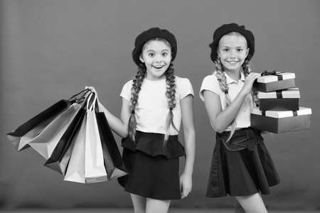 Kids girls hold bunch shopping bags or birthday gifts packages.の写真素材