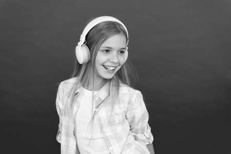 Online radio station channel. Girl child listen music modern headphones. Get music account subscription. Enjoy music concept. Music always with me. Leisure concept. Little girl listen song headphonesの写真素材