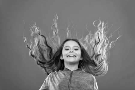 Small girl child. Hairdresser for kids. childrens day. Portrait of happy little child. Kid fashion and sportswear. childhood happiness. Family. Happy little girl with long hair. I wishの写真素材