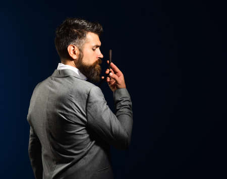 Barbershop advertising concept. Macho in formal suit shaves beard