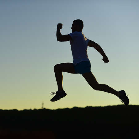 Sport and training concept. Sportsman jogging in evening.の写真素材