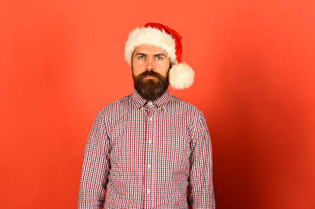 Christmas time concept. Man with serious face on red backgroundの写真素材