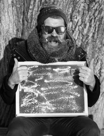 winter bearded man with board on natural background, copy spaceの写真素材